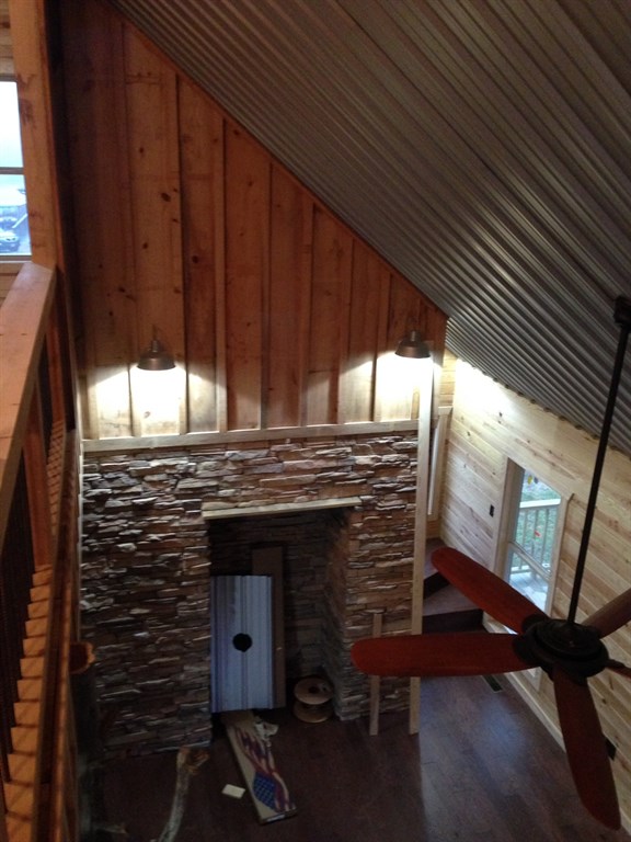 Fireplace w/ board and bat cypress above