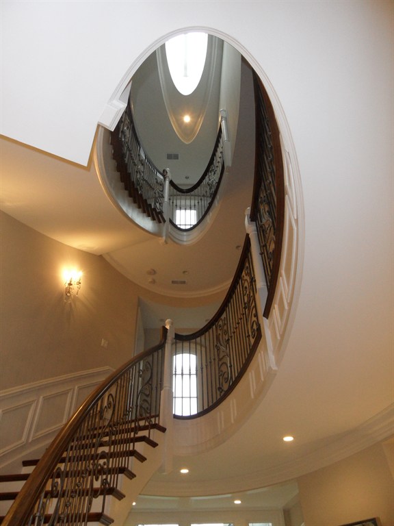 Eliptical Staircase with Custom Wrought Iron Panels