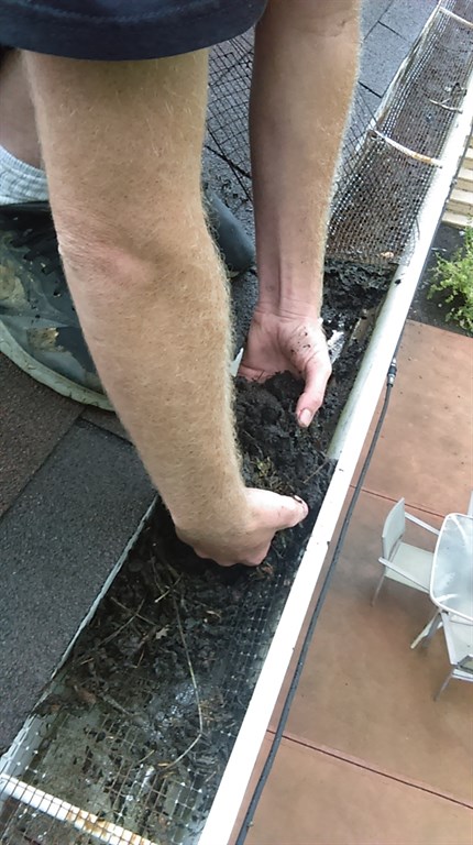 Removing clogged debris from gutters