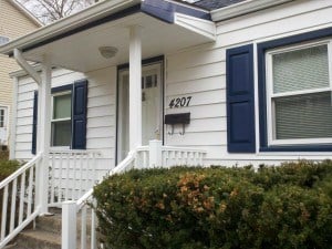 Flat roofed porch with Custom vinyl shutters