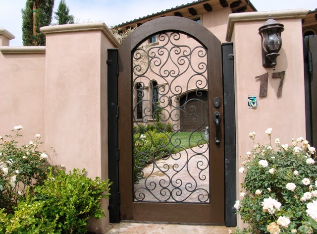 African mahogany gate with hand forged decorative iron