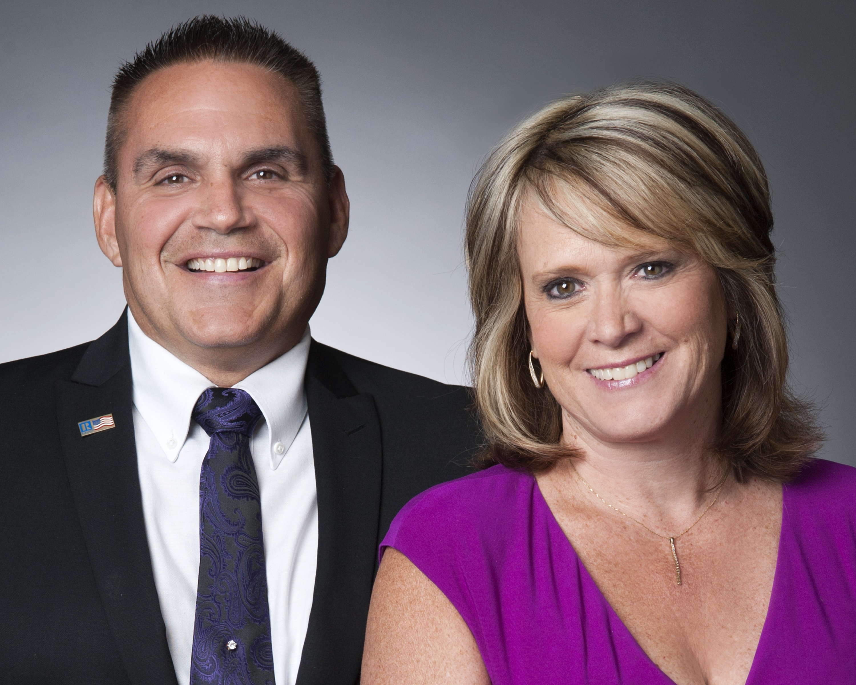 Skyler and Brenda Deems with Berkshire Hathaway logo